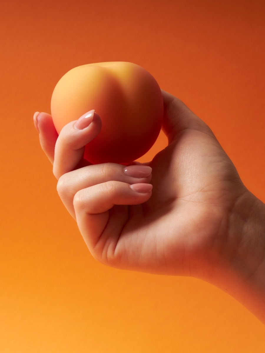 Womanizer Peach Toy stimulateur clitoridien